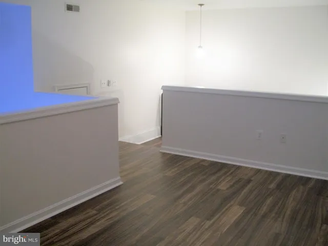 a view of an empty room and wooden floor