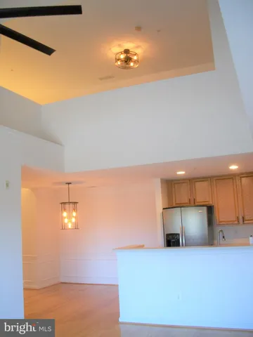 a view of room with wooden floor and fan