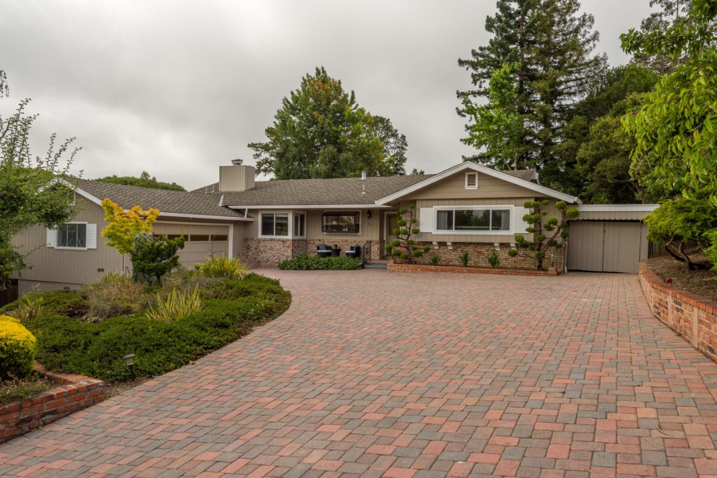 95 Avondale Road Hillsborough, CA 94010 - Photo 1 of 25 a front view of a house with a yard and potted plants