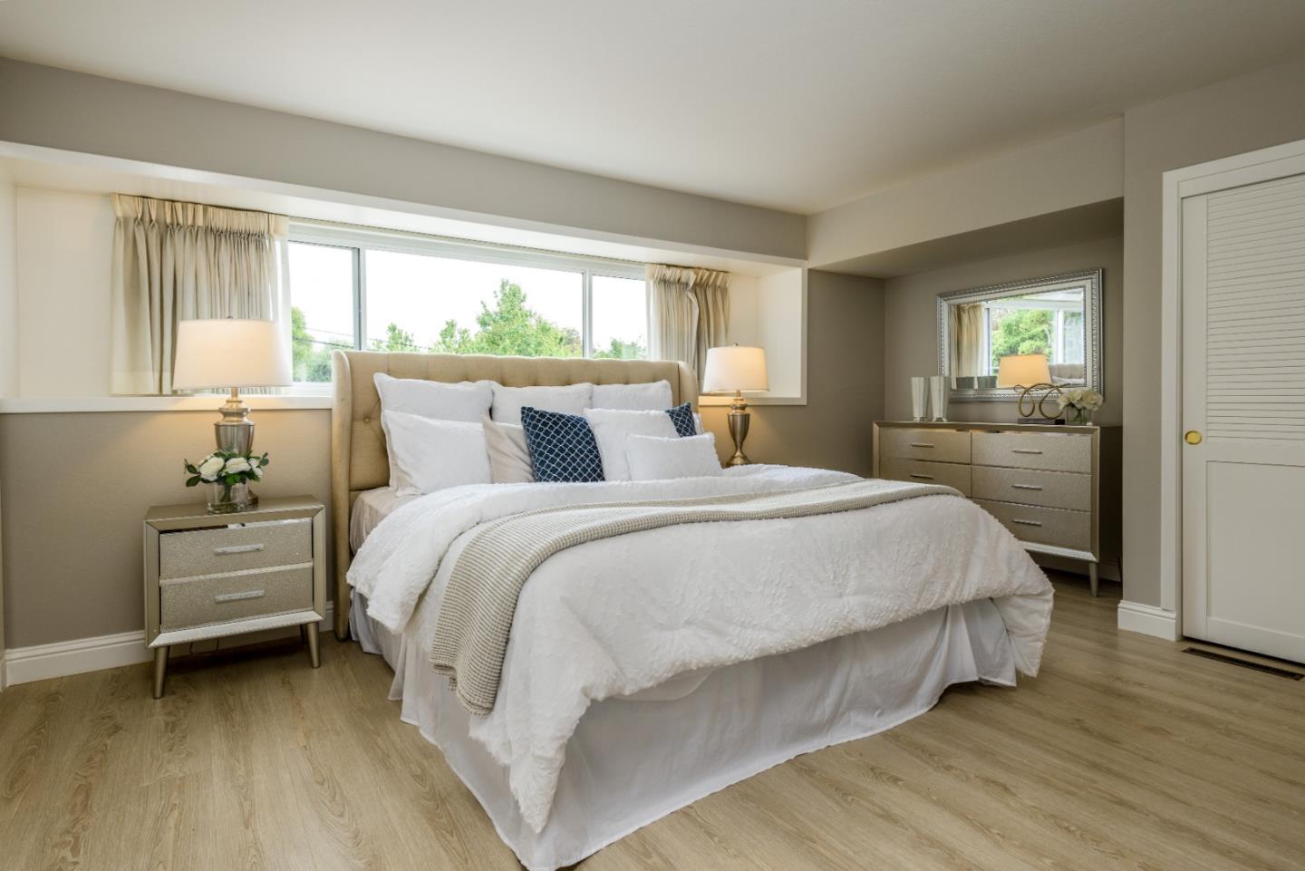 95 Avondale Road Hillsborough, CA 94010 - Photo 13 of 25 a bedroom with a bed and a large window