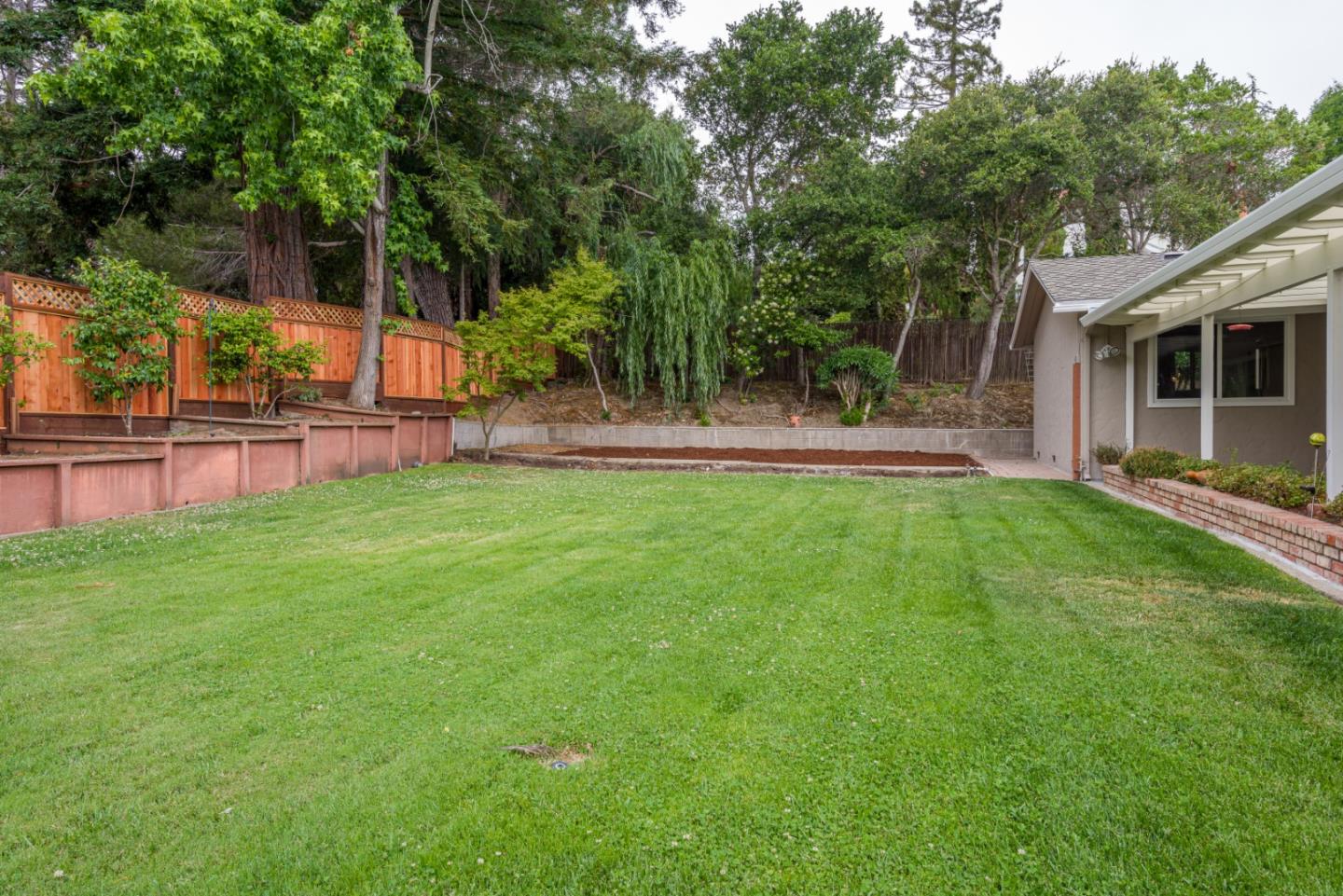 95 Avondale Road Hillsborough, CA 94010 - Photo 21 of 25 a view of a backyard with a garden and trees
