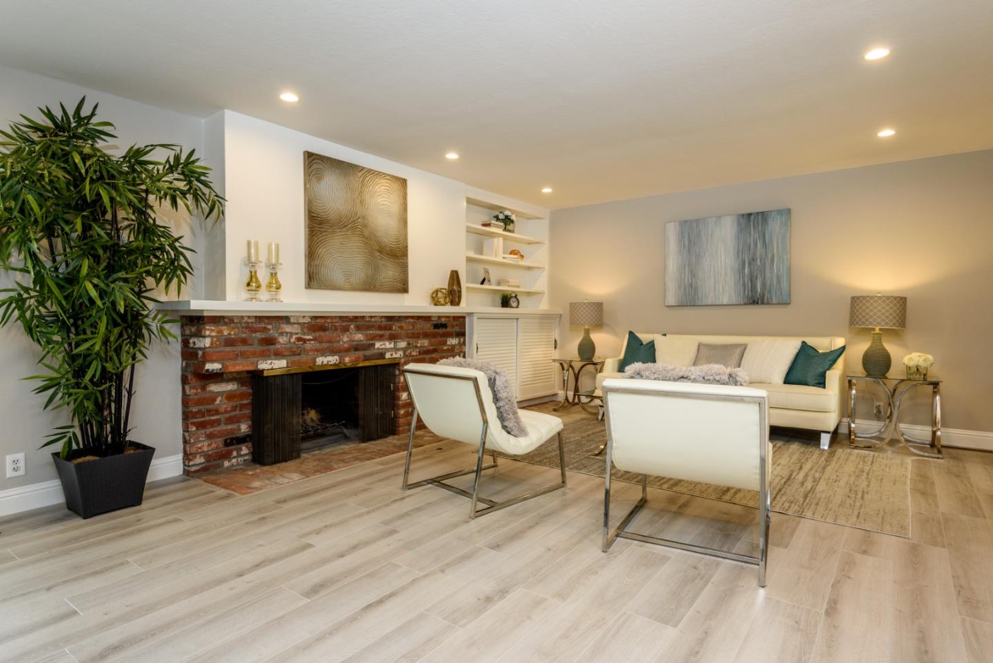 95 Avondale Road Hillsborough, CA 94010 - Photo 4 of 25 a living room with furniture a fireplace and a potted plant