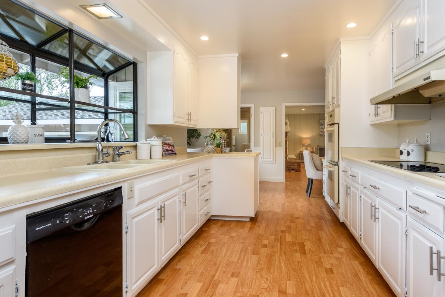 95 Avondale Road Hillsborough, CA 94010 - Photo 8 of 25 a view of a kitchen with a sink and wooden cabinets