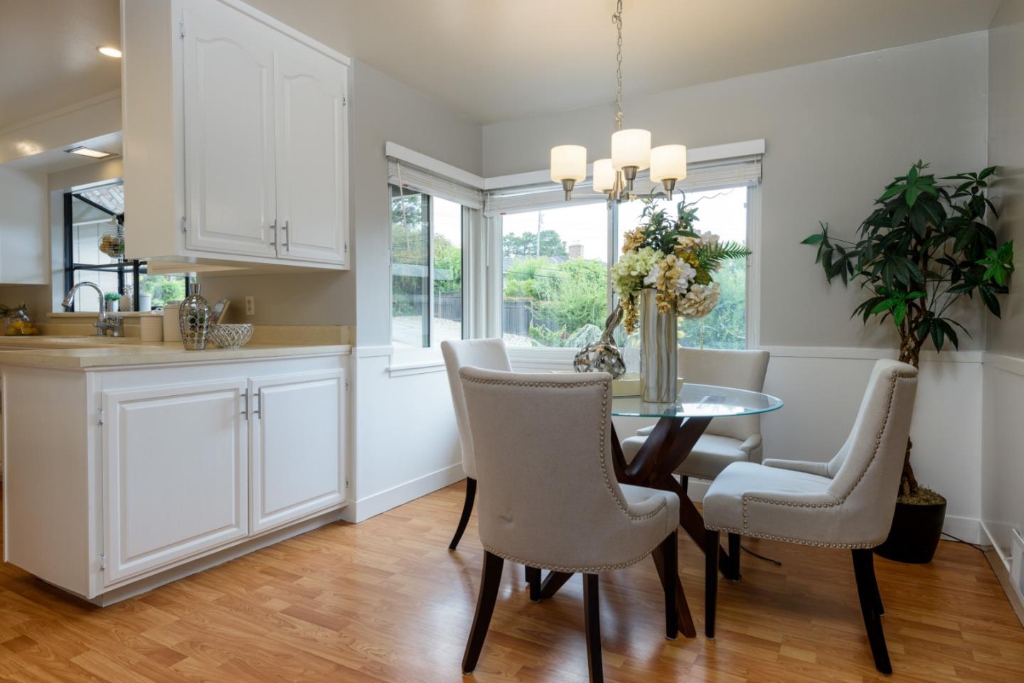 95 Avondale Road Hillsborough, CA 94010 - Photo 9 of 25 a dining room with furniture potted plants and wooden floor
