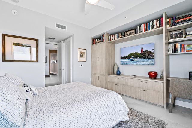 a bedroom with a bed and a book shelf