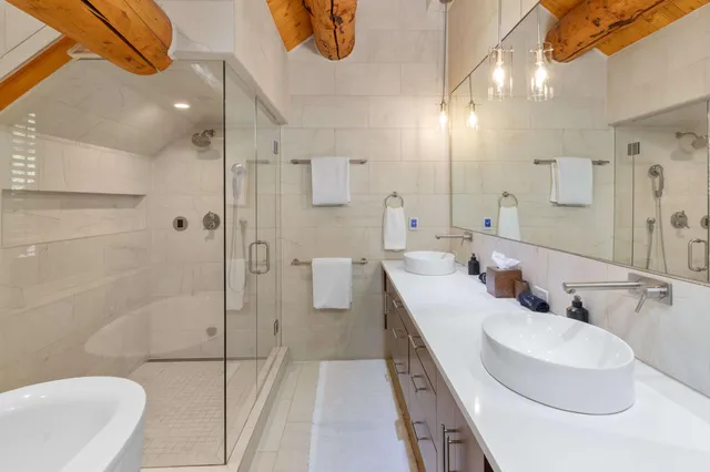 a living room with furniture and floor to ceiling windows