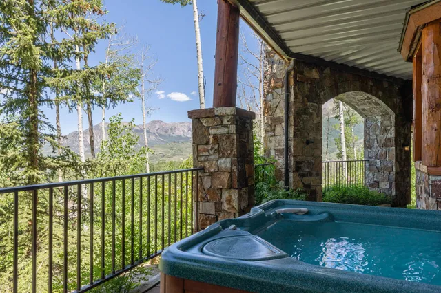 a view of a balcony with two chairs and a table