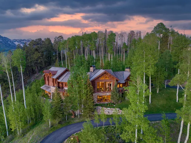 a swimming pool with trees in front of it