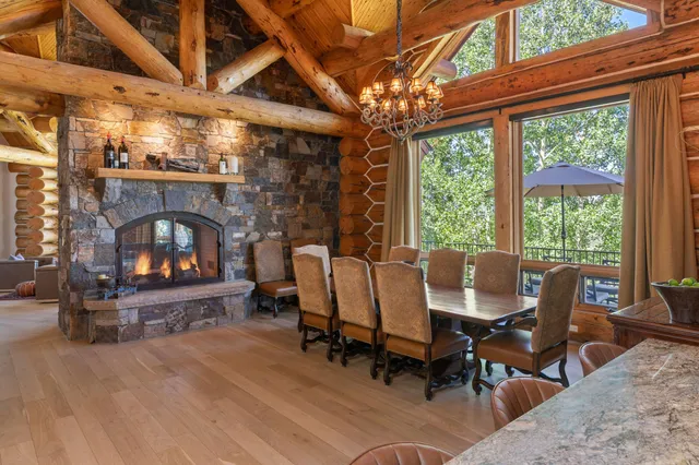 a living room with furniture a fireplace and a table