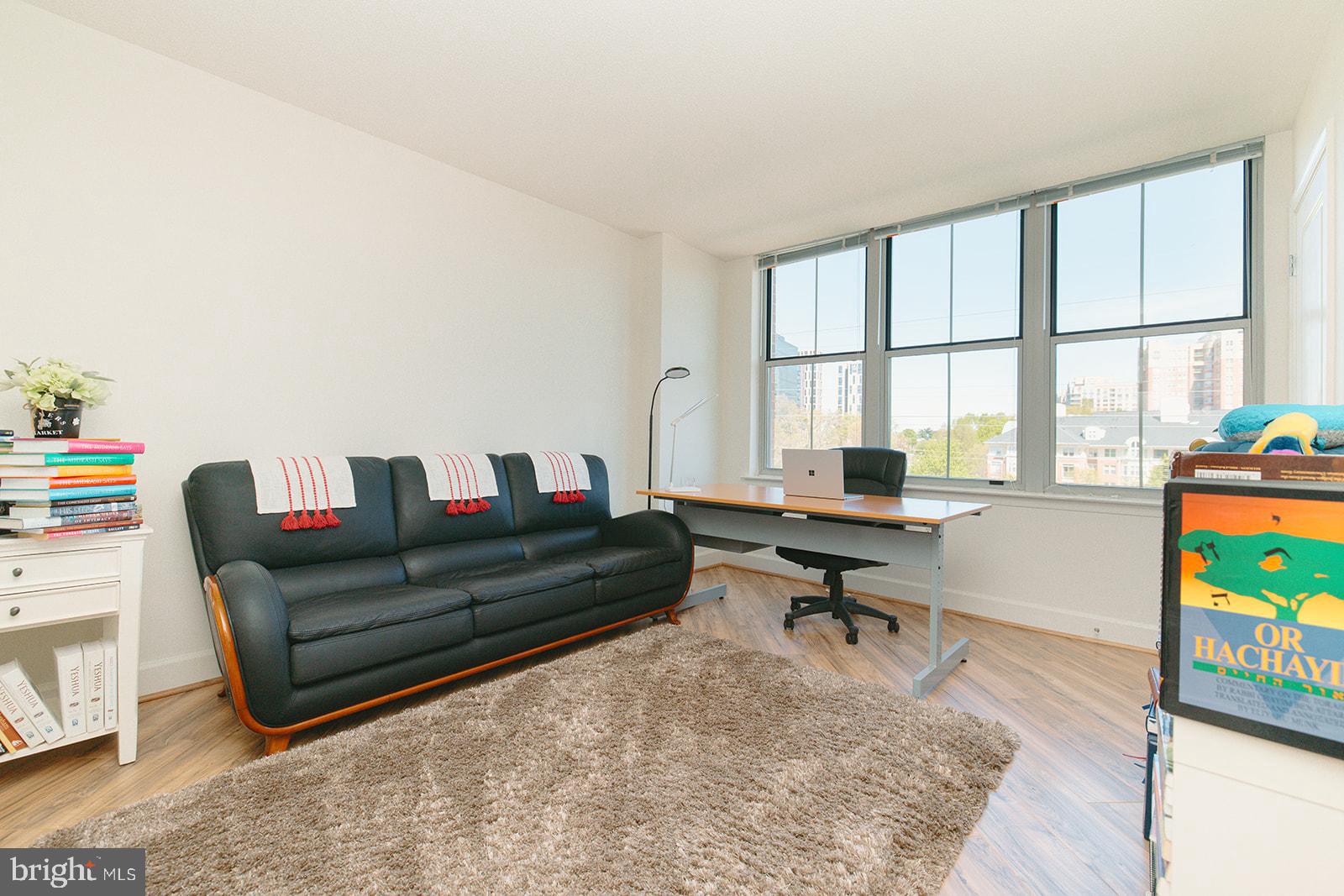 11800 Sunset Hills Road, Unit 506 Reston, VA 20190 - Photo 13 of 30 a living room with furniture and a flat screen tv
