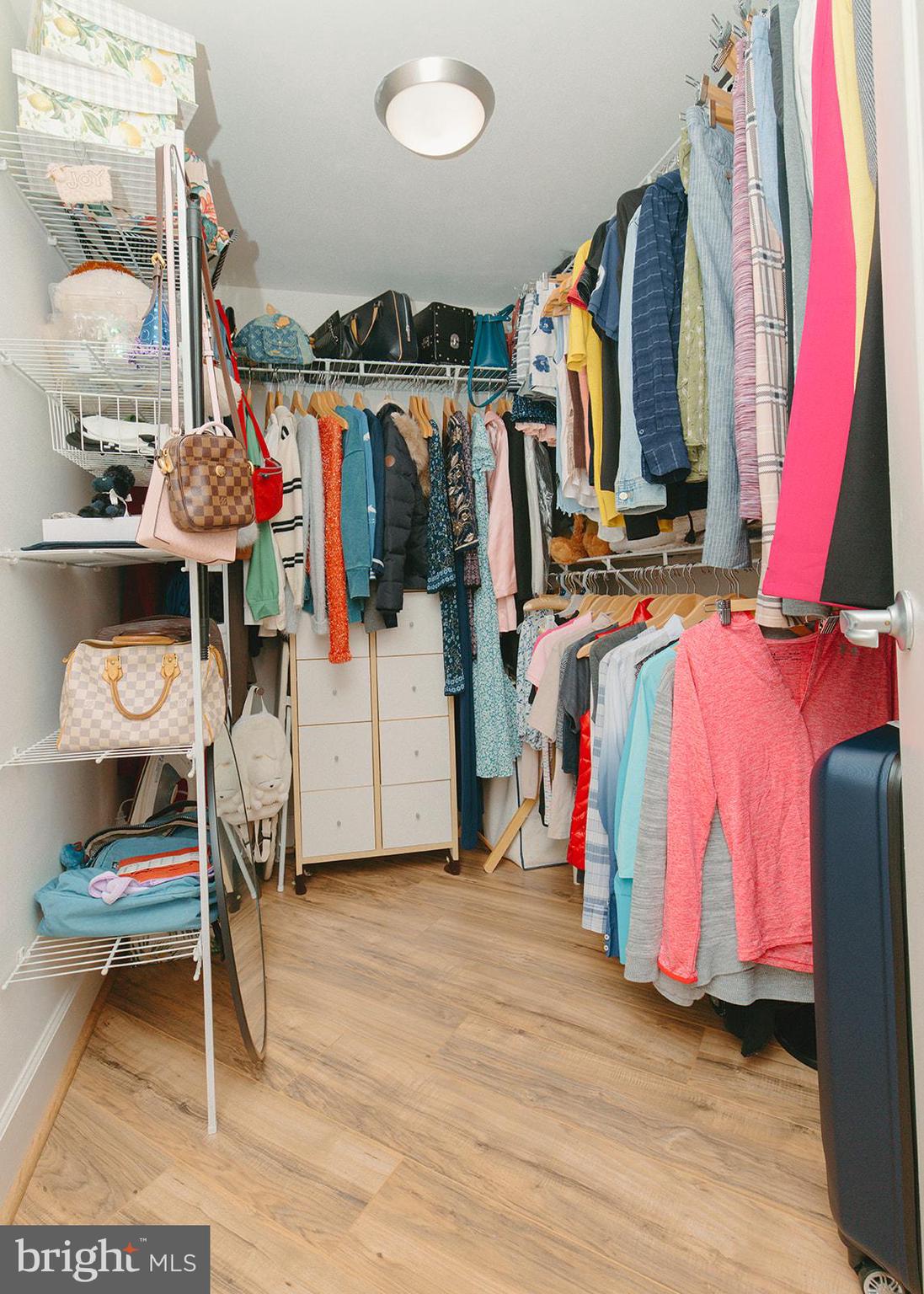 11800 Sunset Hills Road, Unit 506 Reston, VA 20190 - Photo 14 of 30 a view of walk in closet with clothes and shoes