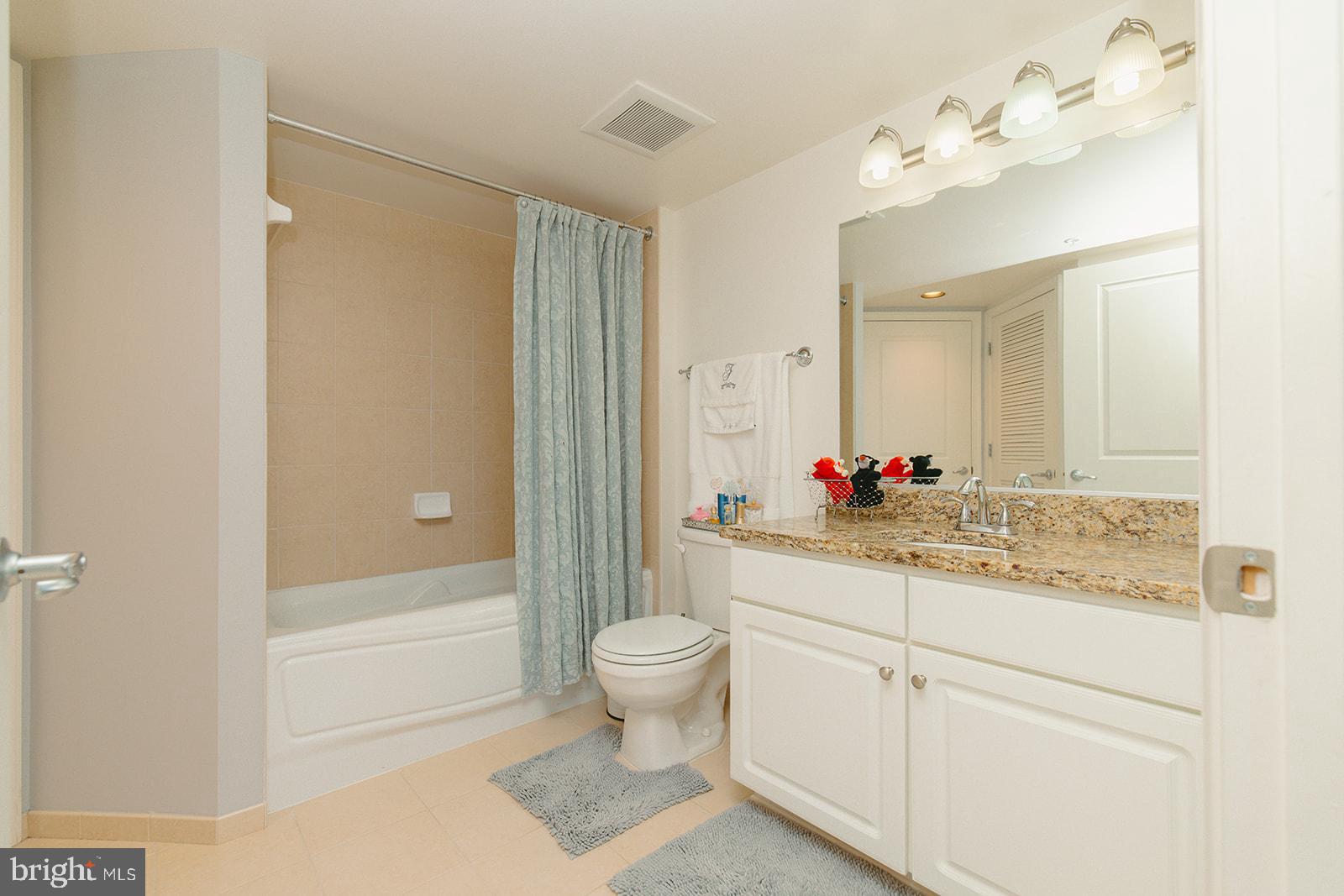 11800 Sunset Hills Road, Unit 506 Reston, VA 20190 - Photo 15 of 30 a bathroom with a sink vanity mirror and toilet