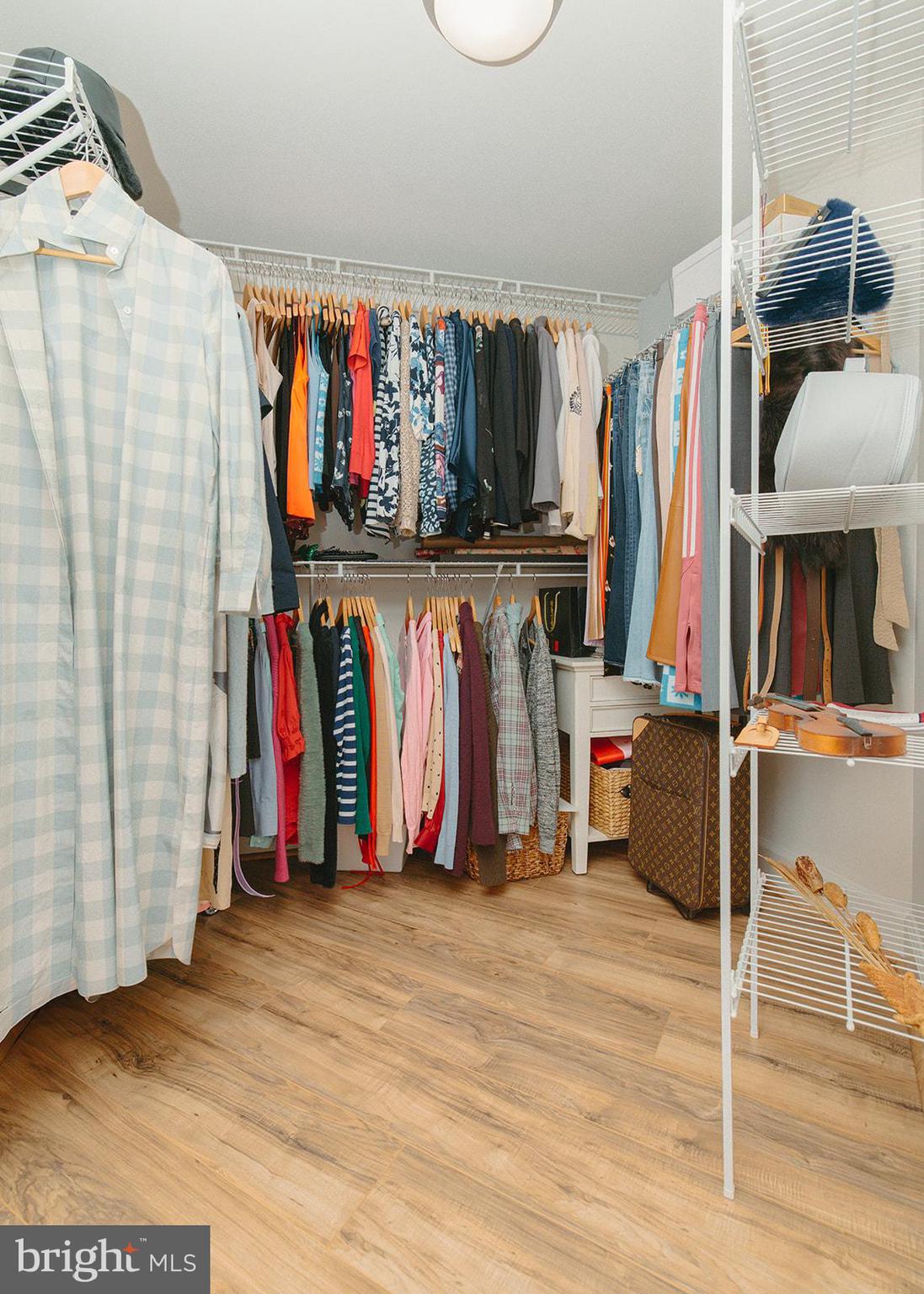 11800 Sunset Hills Road, Unit 506 Reston, VA 20190 - Photo 18 of 30 a view of walk in closet with clothes and shoes