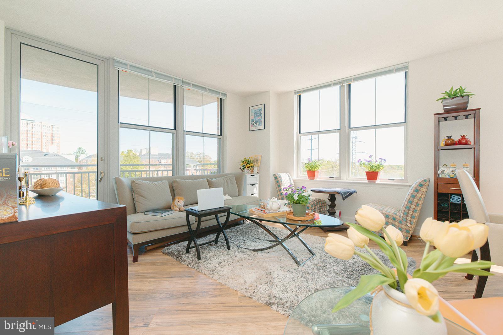 11800 Sunset Hills Road, Unit 506 Reston, VA 20190 - Photo 5 of 30 a living room with furniture and a floor to ceiling window