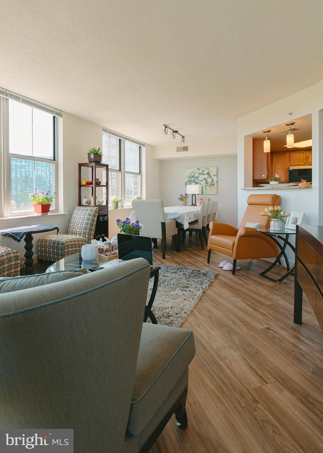 11800 Sunset Hills Road, Unit 506 Reston, VA 20190 - Photo 7 of 30 a living room with furniture and a table