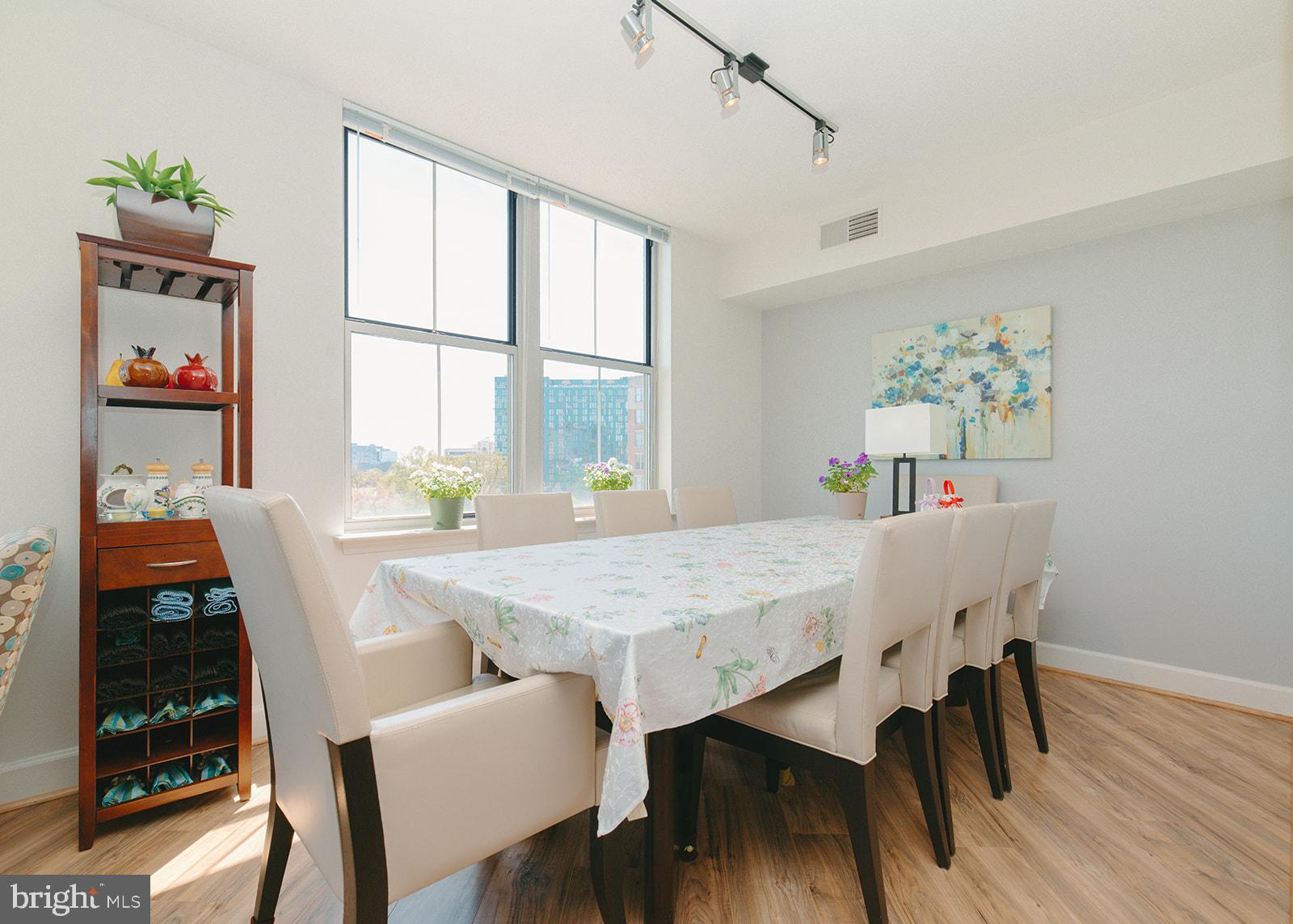 11800 Sunset Hills Road, Unit 506 Reston, VA 20190 - Photo 8 of 30 a view of a dining room with furniture wooden floor and chandelier