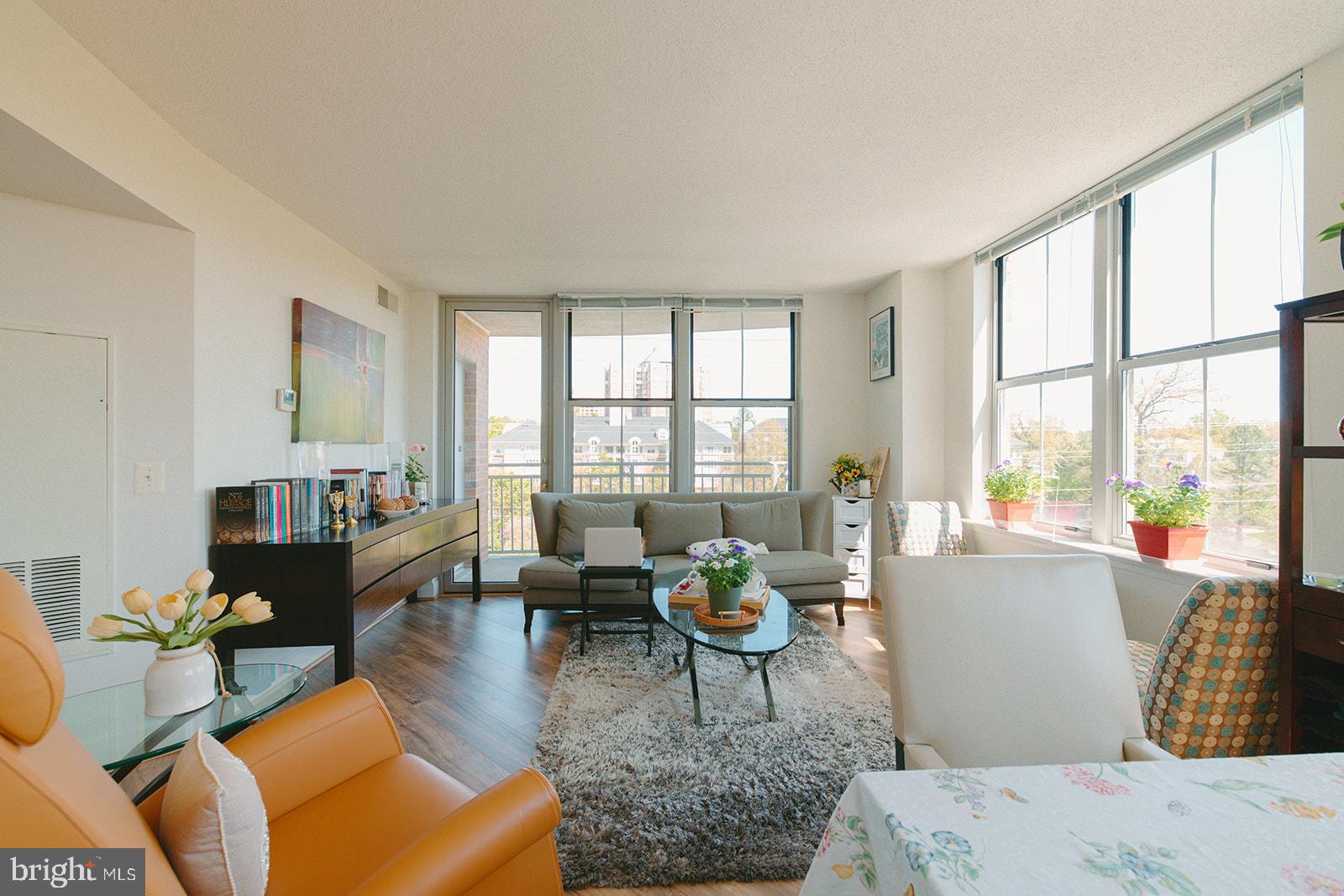 11800 Sunset Hills Road, Unit 506 Reston, VA 20190 - Photo 9 of 30 a living room with furniture and a large window