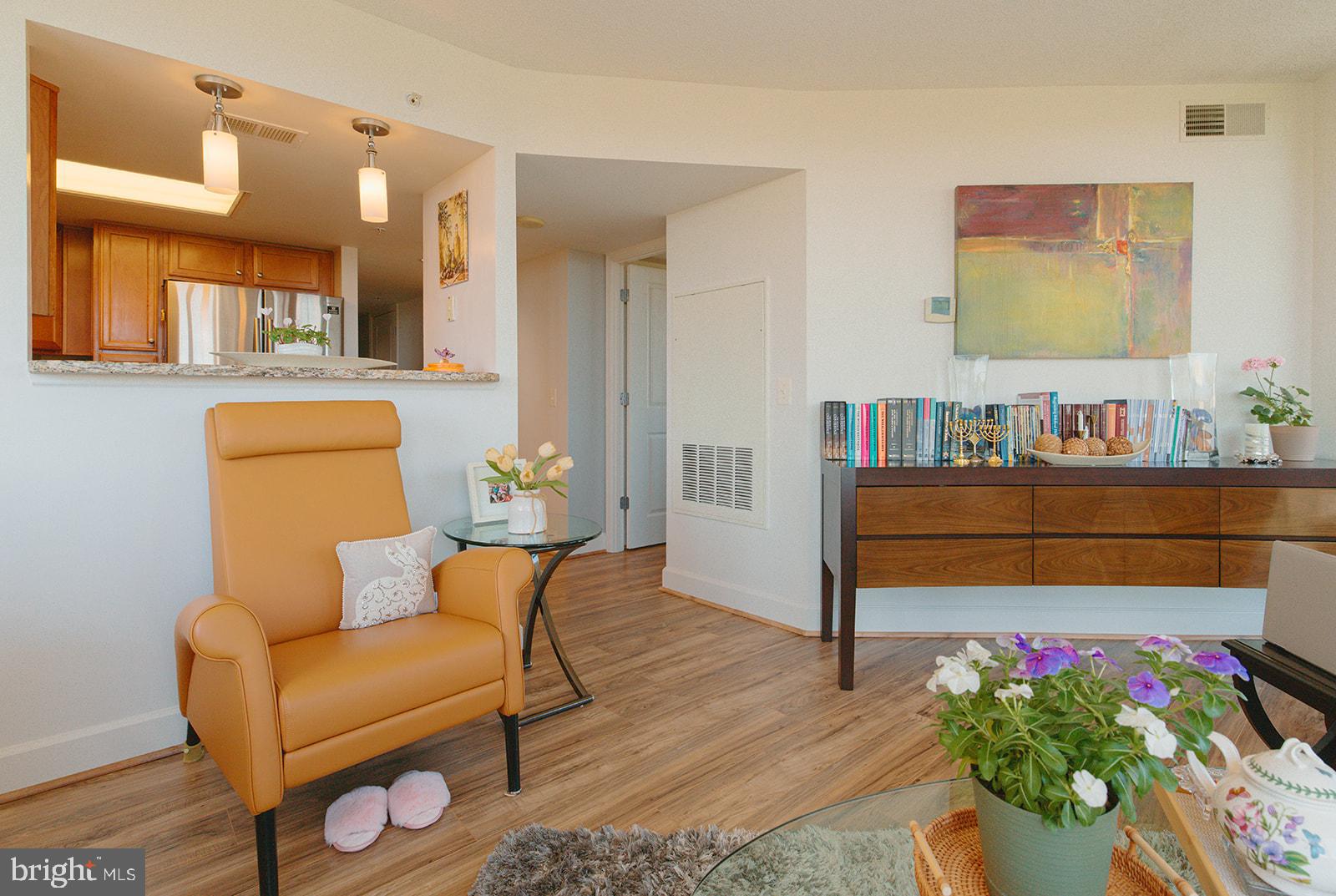 11800 Sunset Hills Road, Unit 506 Reston, VA 20190 - Photo 10 of 30 a living room with furniture and flowers