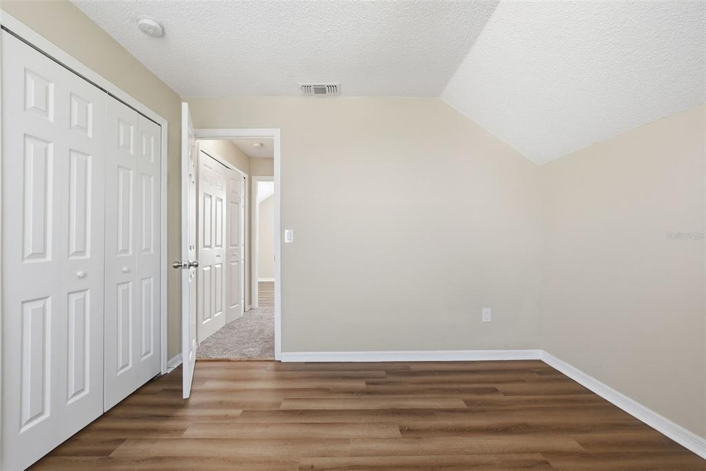 617 Greys Ferry Road Orlando, FL 32811 - Photo 23 of 35 a view of an empty room with wooden floor