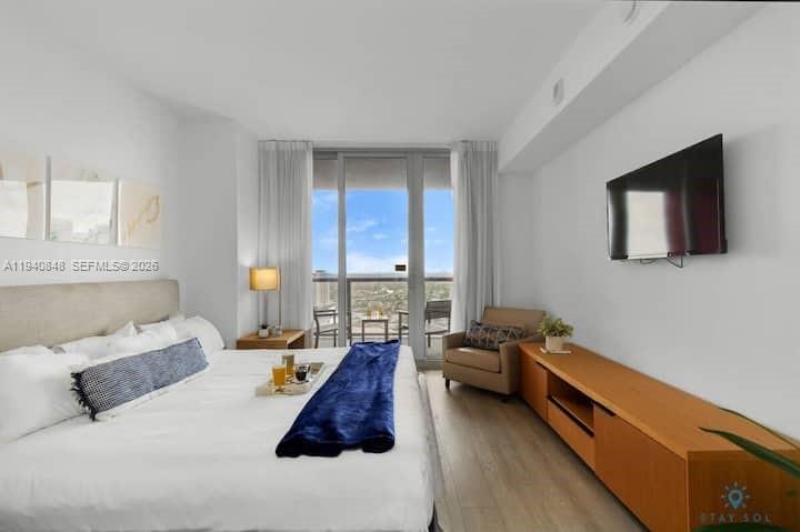 2602 East Hallandale Beach Boulevard, Unit R2006 Hallandale Beach, FL 33009 - Photo 10 of 24 a spacious bedroom with a bed and a flat screen tv