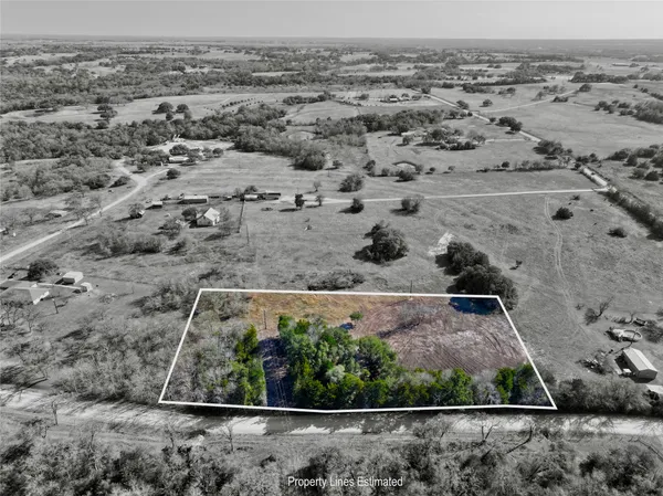 an aerial view of house with a yard