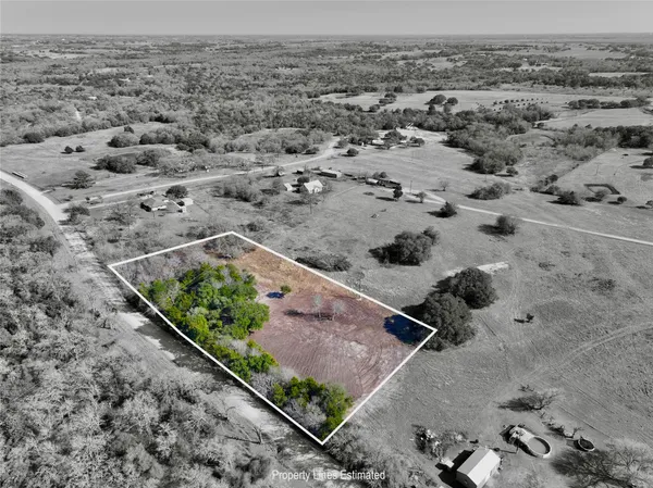 an aerial view of a houses with a yard
