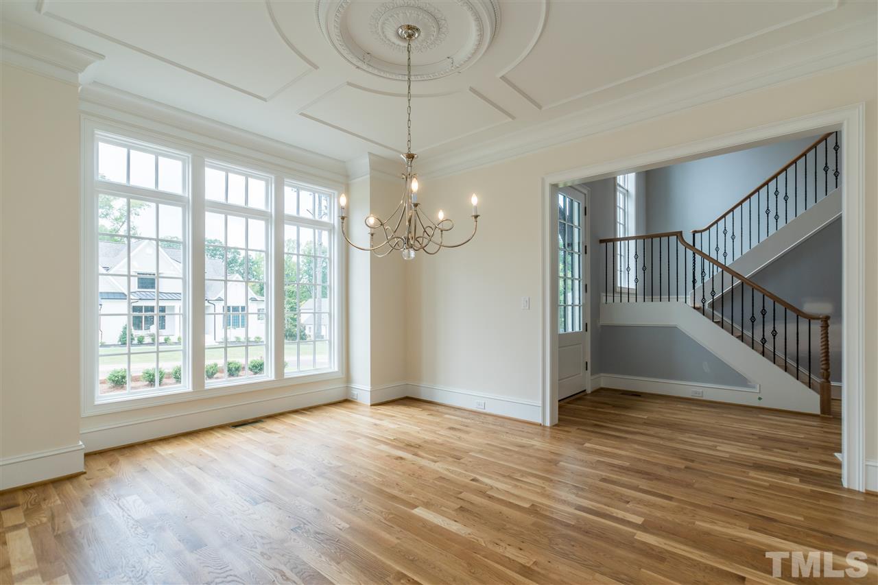 5412 Winding View Lane Raleigh, NC 27615 - Photo 13 of 30 a view of an empty room with wooden floor and fan