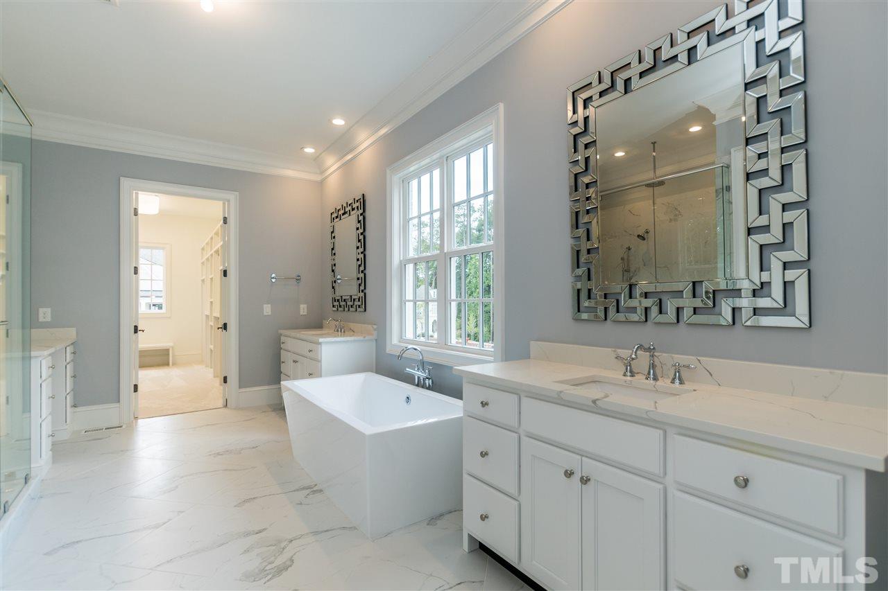 5412 Winding View Lane Raleigh, NC 27615 - Photo 15 of 30 a spacious bathroom with a double vanity sink mirror double and bathtub