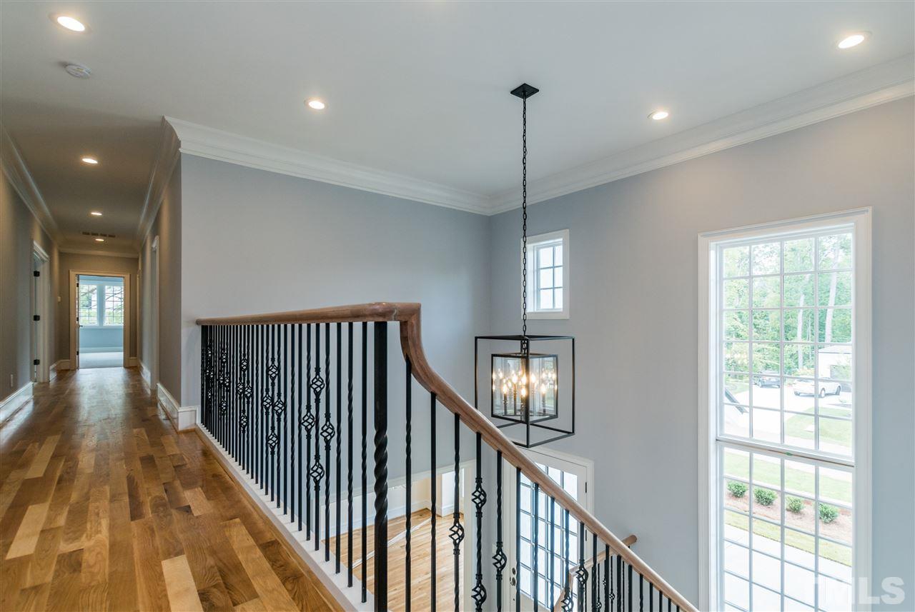 5412 Winding View Lane Raleigh, NC 27615 - Photo 24 of 30 a view of a hallway with wooden floor and chandelier