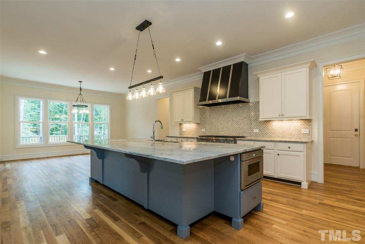 5412 Winding View Lane Raleigh, NC 27615 - Photo 6 of 30 a kitchen with stainless steel appliances granite countertop a sink a stove and a wooden floors