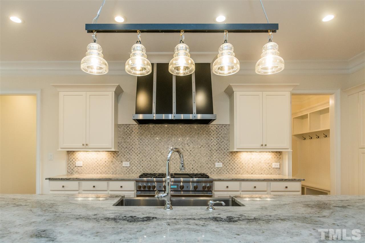 5412 Winding View Lane Raleigh, NC 27615 - Photo 7 of 30 a kitchen with stainless steel appliances granite countertop a stove a sink and a microwave