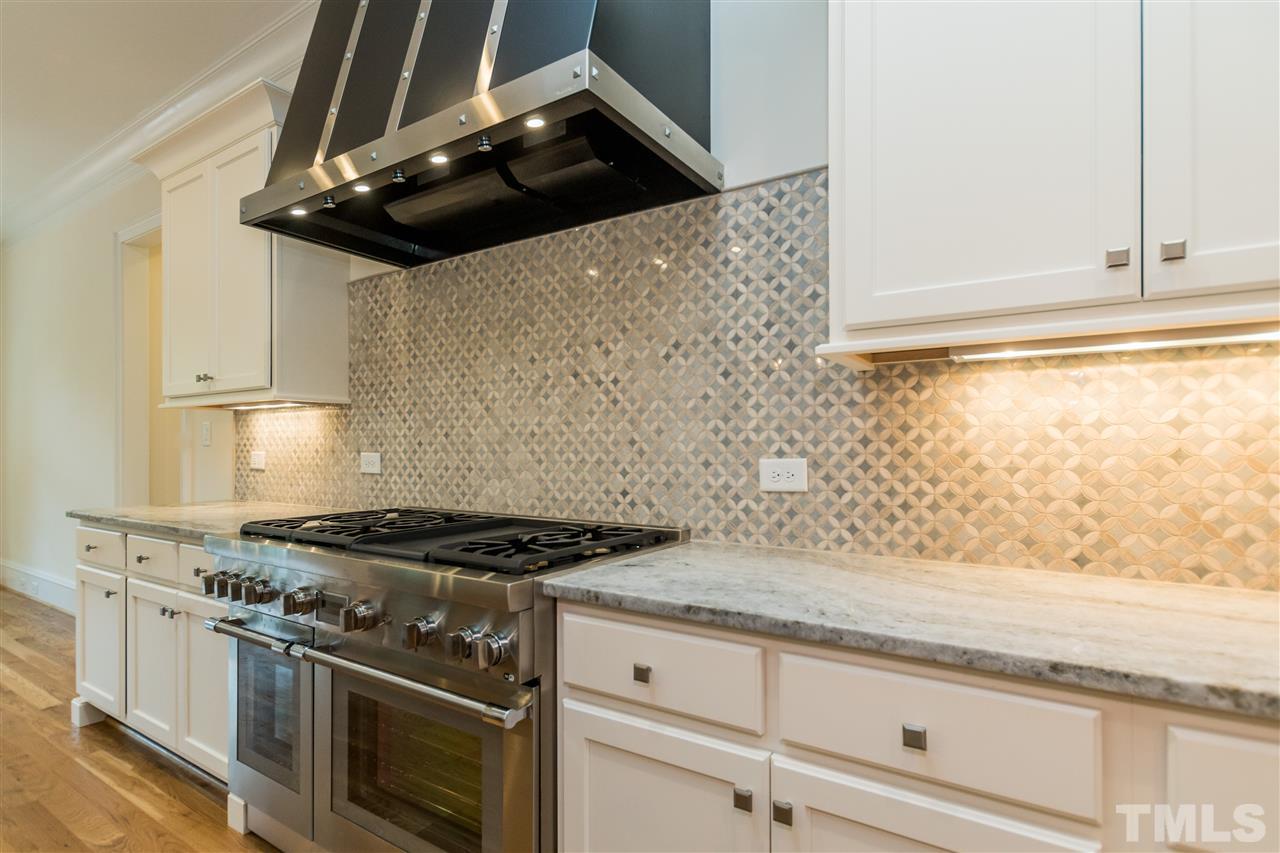 5412 Winding View Lane Raleigh, NC 27615 - Photo 8 of 30 a stove top oven sitting inside of a kitchen