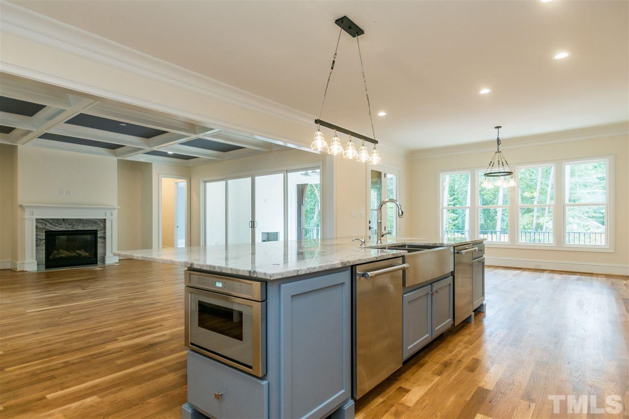 5412 Winding View Lane Raleigh, NC 27615 - Photo 10 of 30 a kitchen with stainless steel appliances granite countertop a stove and a wooden floors