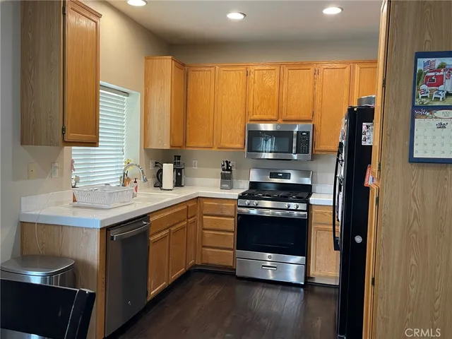 a kitchen with stainless steel appliances granite countertop a stove and a sink