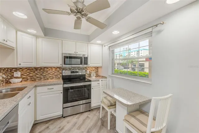 a view of a house with backyard porch and sitting area