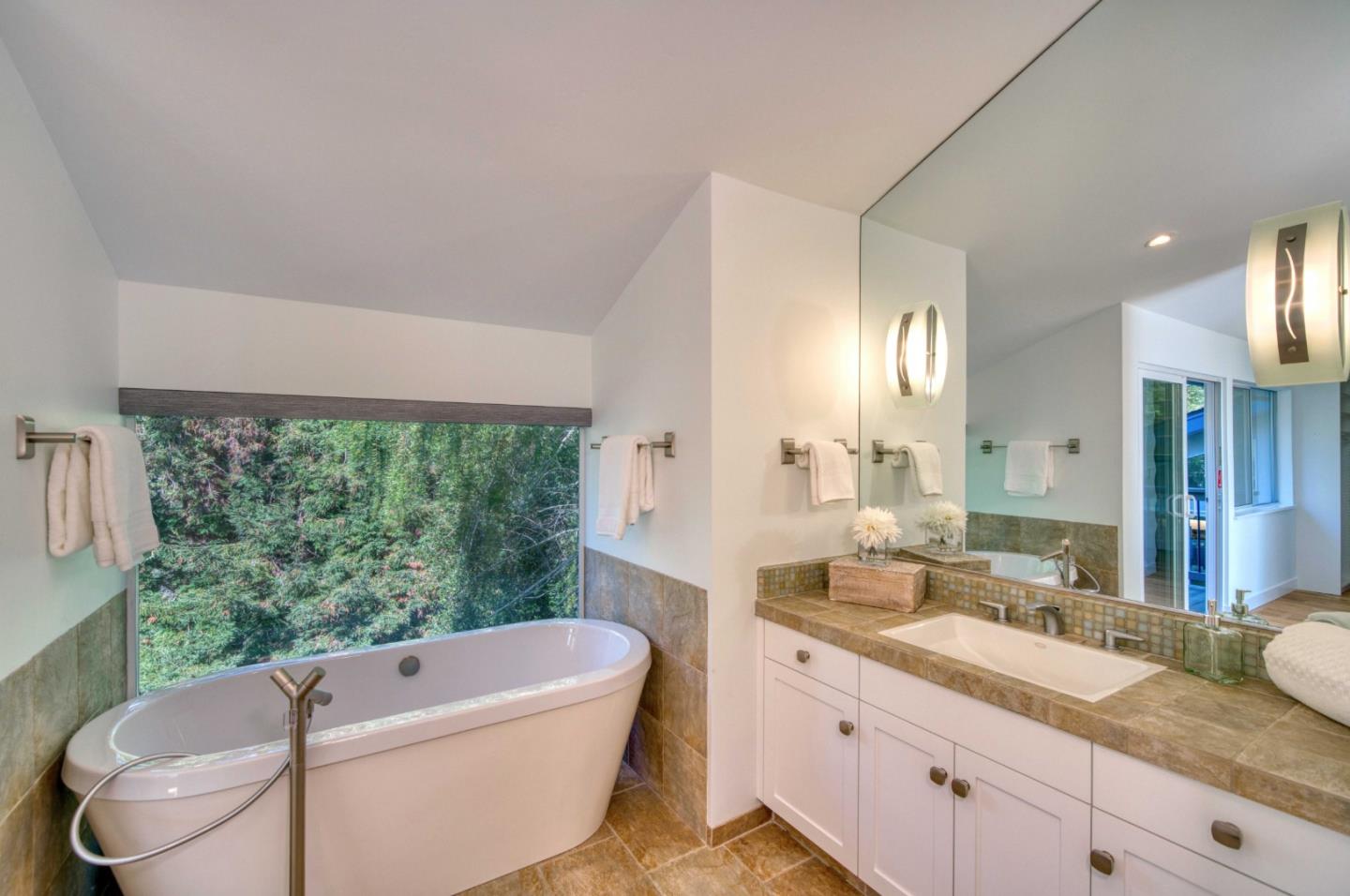 7325 Viewpoint Road Aptos, CA 95003 - Photo 24 of 51 a bathroom with a granite countertop sink a toilet a mirror and bathtub