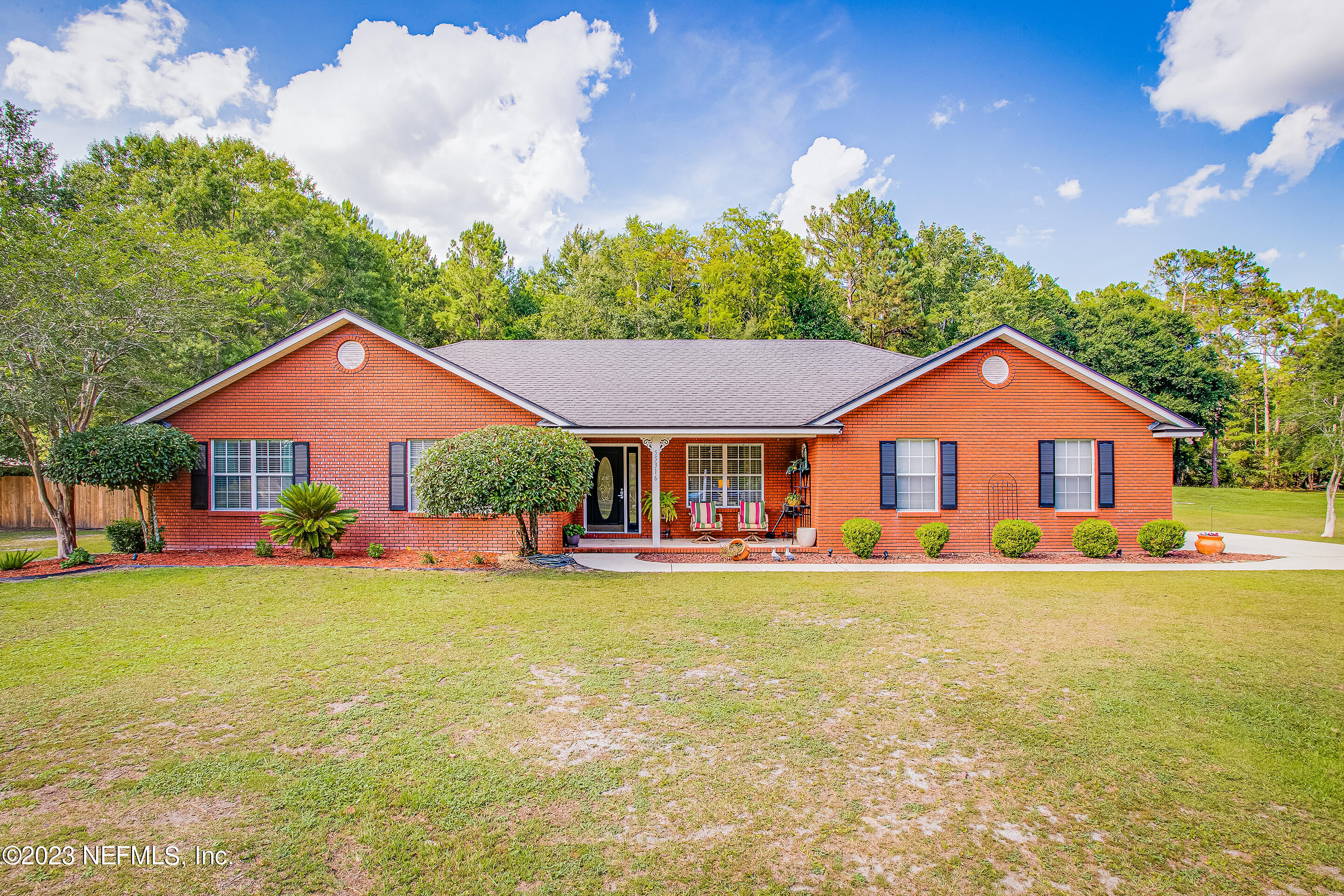 55316 Deer Run Road Callahan, FL 32011 - Photo 1 of 32 a front view of a house with yard and green space