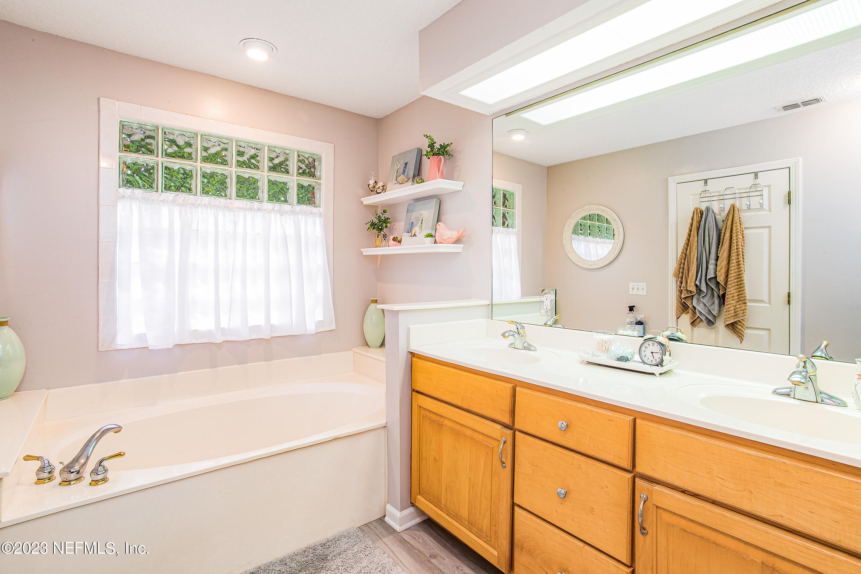 55316 Deer Run Road Callahan, FL 32011 - Photo 16 of 32 a bathroom with a granite countertop sink mirror and bathtub