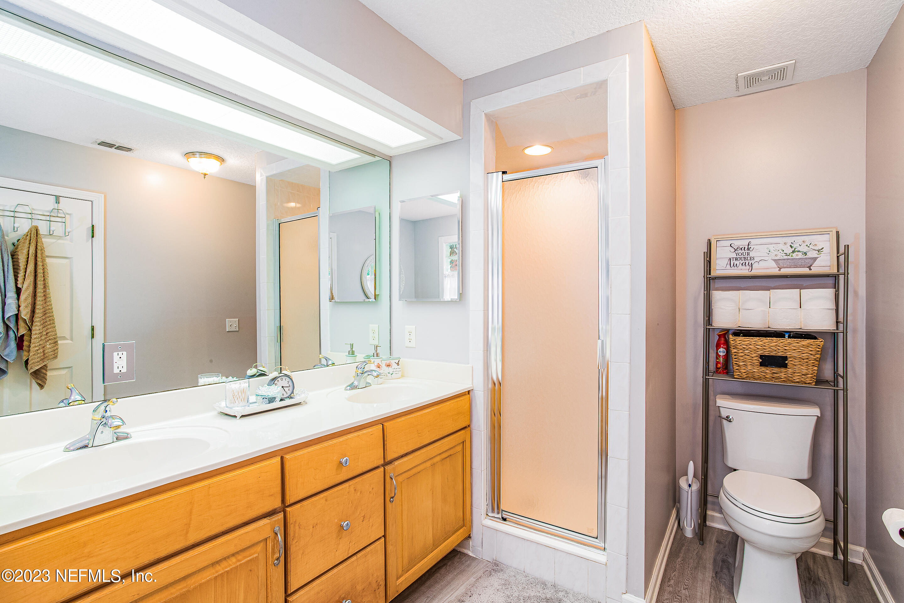 55316 Deer Run Road Callahan, FL 32011 - Photo 17 of 32 a bathroom with a granite countertop toilet sink and mirror