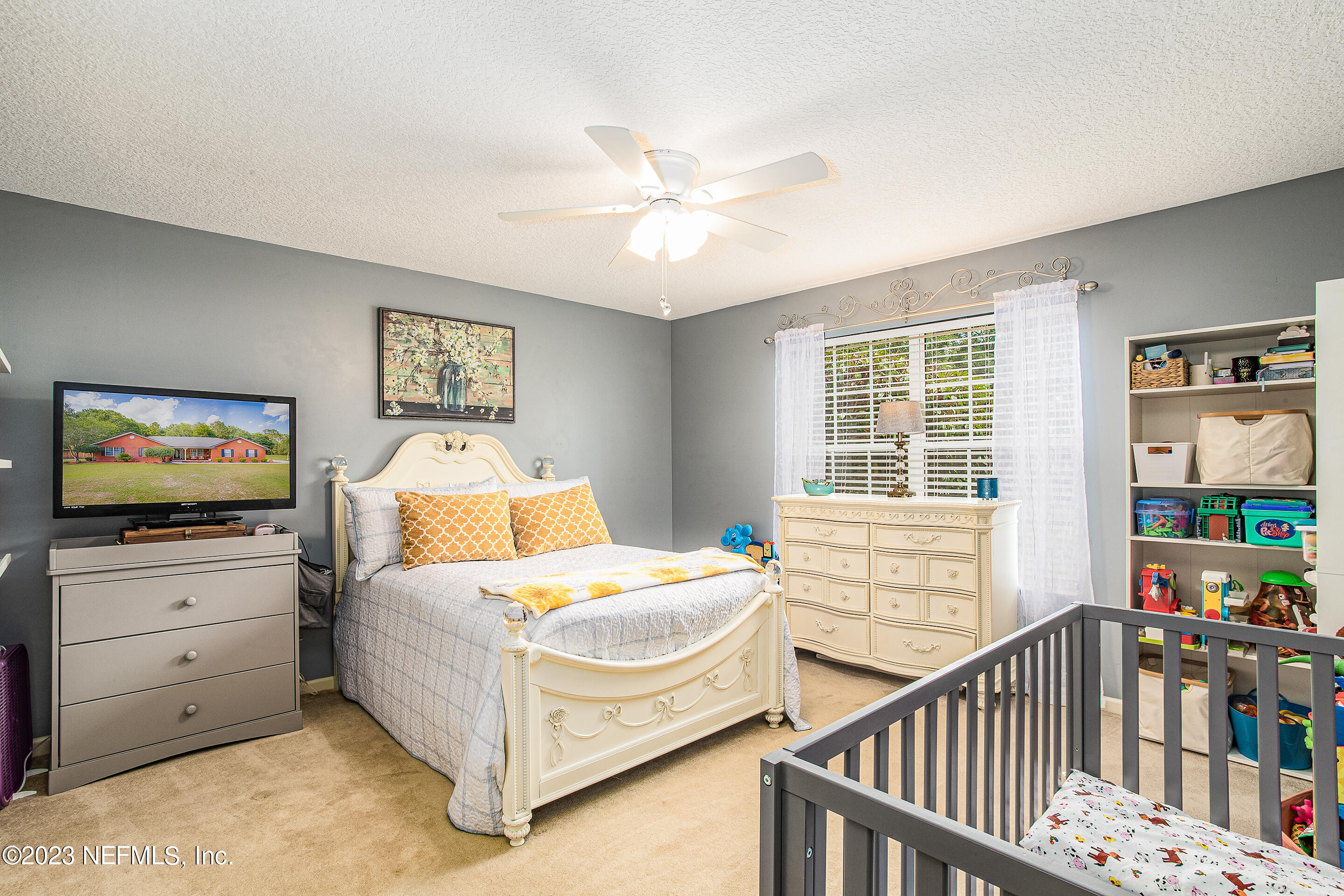 55316 Deer Run Road Callahan, FL 32011 - Photo 20 of 32 a bedroom with furniture and a flat screen tv