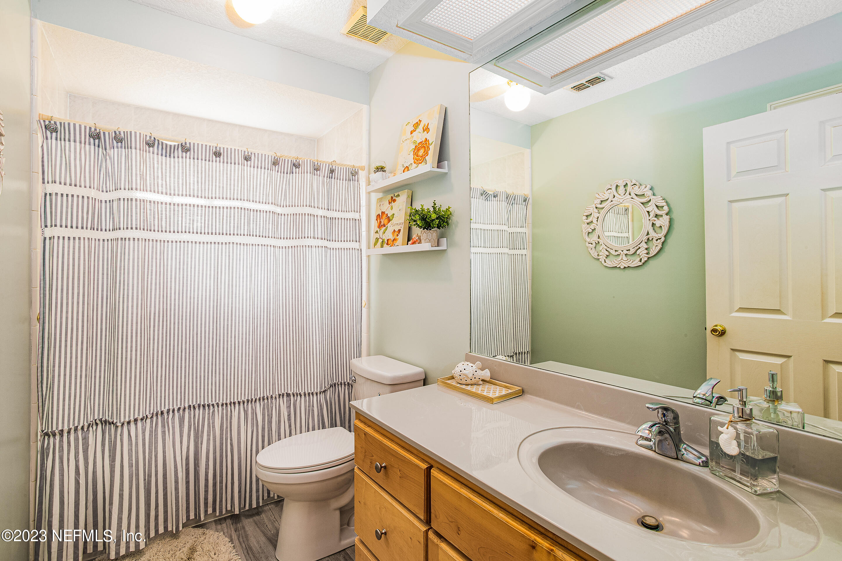 55316 Deer Run Road Callahan, FL 32011 - Photo 22 of 32 a bathroom with a sink a toilet and a mirror