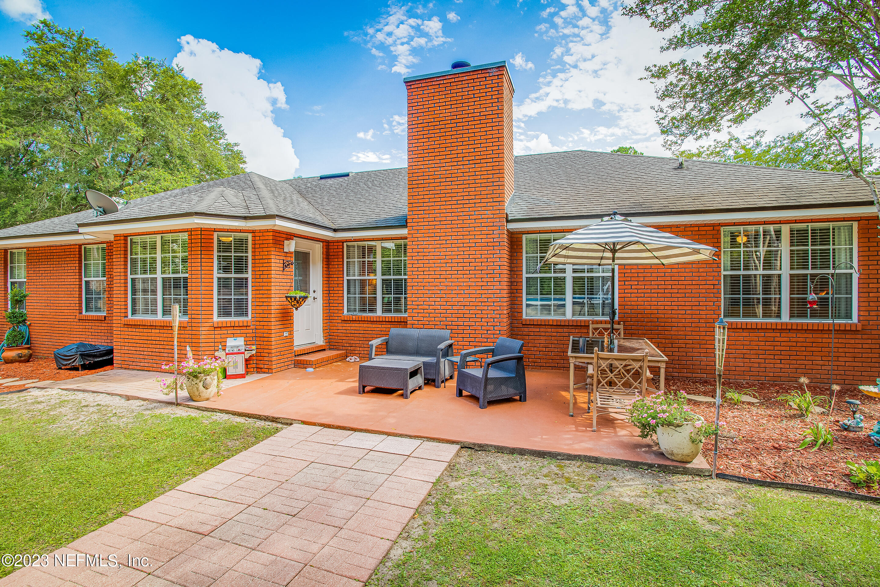 55316 Deer Run Road Callahan, FL 32011 - Photo 23 of 32 a view of a house with backyard sitting area and garden