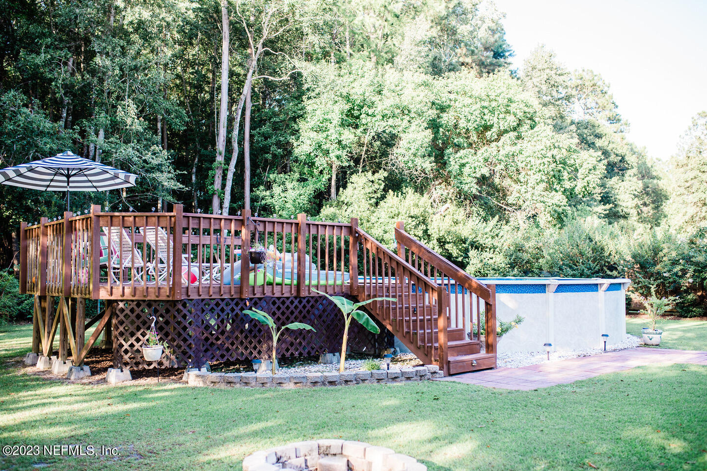 55316 Deer Run Road Callahan, FL 32011 - Photo 28 of 32 a view of a deck with a small yard and large trees