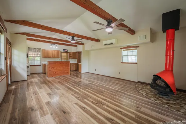 a room with a window and wooden floor