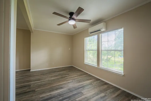 wooden floor in an empty room with a window