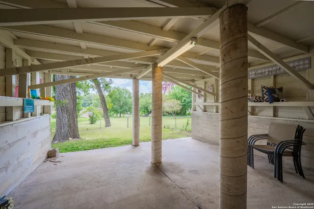 a view of backyard of house with green space