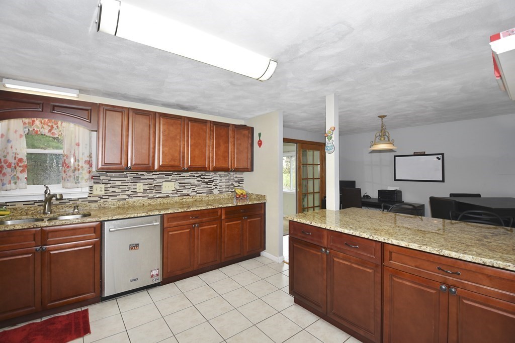 39 Tanglewood Road Sterling, MA 01564 - Photo 11 of 30 a kitchen with granite countertop stainless steel appliances a sink stove and cabinets