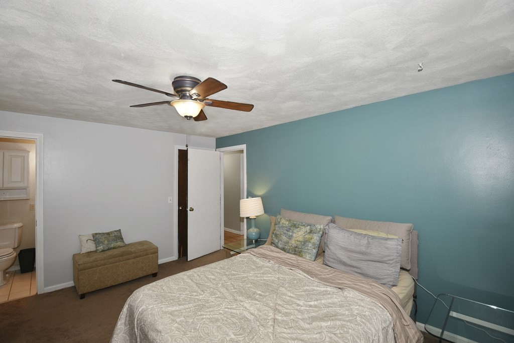 39 Tanglewood Road Sterling, MA 01564 - Photo 16 of 30 a bedroom with a bed and a chandelier