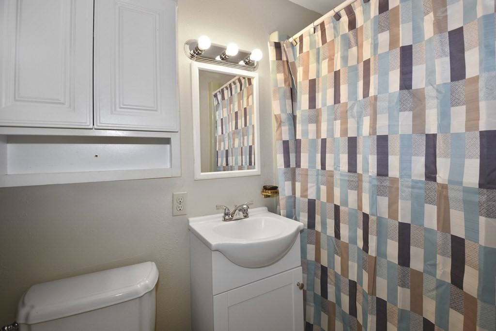 39 Tanglewood Road Sterling, MA 01564 - Photo 20 of 30 a bathroom with a sink a toilet and shower curtain