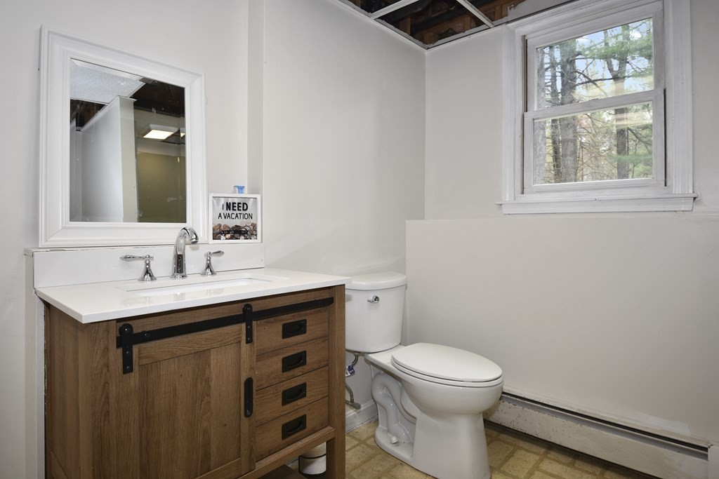 39 Tanglewood Road Sterling, MA 01564 - Photo 24 of 30 a bathroom with a toilet a sink and a mirror